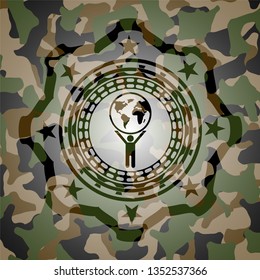 man lifting world icon on camouflaged texture