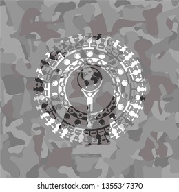 man lifting world icon on grey camouflage pattern