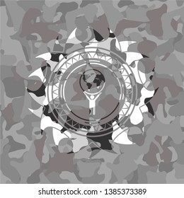 man lifting world icon on grey camouflaged texture