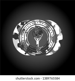 man lifting world icon on grey camouflaged texture