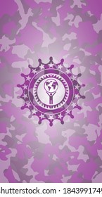 man lifting world icon on pink camouflage texture. 