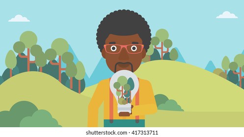 Man with lightbulb and trees inside.