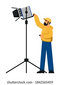 Man lighting technician with spotlight equipment on white