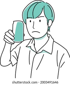 A man looking at a can of drink and thinking about something