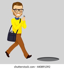 Man looking his smartphone and walking into open manhole