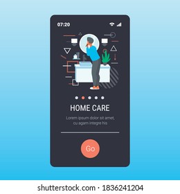 man looking to mirror brushing teeth with toothbrush in bathroom health care dental hygiene concept rear view smartphone screen mobile app copy space vector illustration