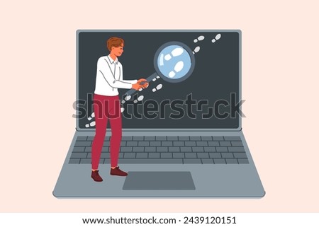 Man is looking for traces on internet, working as OSINT specialist and holding magnifying glass near laptop screen. Detective uses OSINT techniques for reconnaissance using open sources