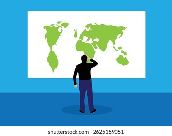 Man Looking at World Map Hanging on the Wall. Following trends in global economy, business and trading