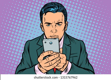 man looks at the smartphone. Pop art retro vector illustration vintage kitsch