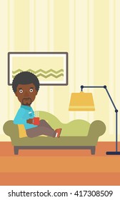 Man lying with cup of tea.