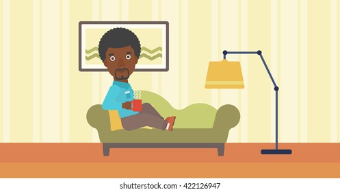 Man lying with cup of tea.