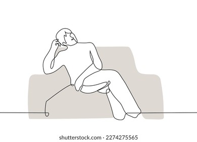 man lying on a sofa or armchair leaning his head with his hand - one line drawing vector. concept laziness, procrastination