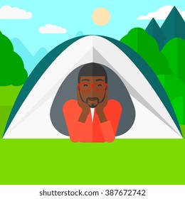 Man lying in tent.