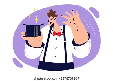 Man magician is holding hat and preparing to demonstrate magic trick of pulling rabbit out of headdress. Magician guy amuses viewer during corporate party or circus performance in front of audience