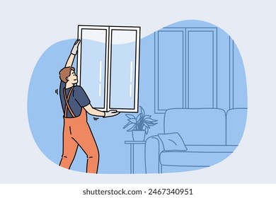 Man master changing windows in apartment, holding casement in hands standing near sofa. Replacing windows in home during renovations to improve energy efficiency and building exterior