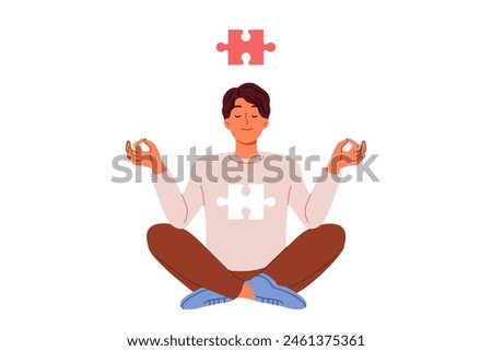 Man meditates sitting in lotus position and feels synchronization of soul in form of puzzle and cosmos thanks to yoga. Guy is interested in zen buddhism and meditation to achieve mental harmony