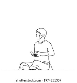 man meditates while sitting