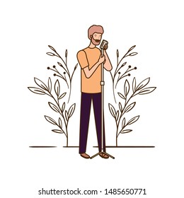 man with microphone and branches and leaves in the background