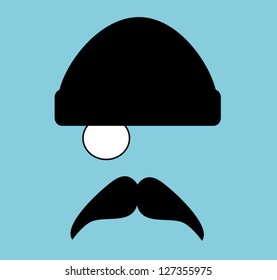 man with monocle and beanie