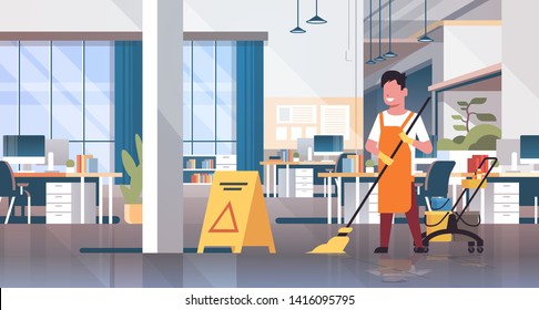 man mopping floor male cleaner janitor in uniform cleaning service concept trolley cart with supplies creative co-working center office interior flat full length horizontal