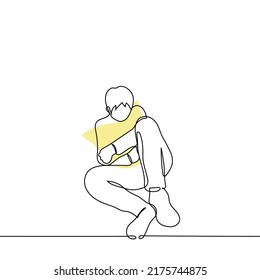 man mourns for a deceased loved one - one line drawing vector. a man sits hugging a photo in a wooden frame with a black stripe. concept sorrow, grief and sense of loss