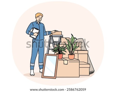 Man mover stands near pile of cardboard boxes advertising services of company that helps with moving to new home. Mover guy in blue uniform works in logistics business providing delivery services.
