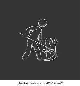 Man mowing grass with scythe. Drawn in chalk icon.