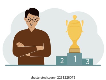 A man next to the pedestal on which the cup for victory and first place.