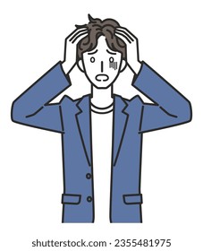 A man in office casual outfit holding his head