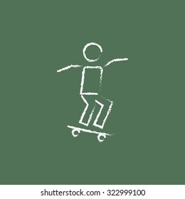 Man on skateboard hand drawn in chalk on a blackboard vector white icon isolated on a green background.