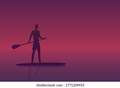 Man on a sup board at sunset