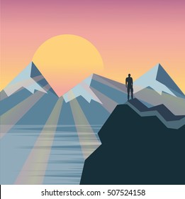 Man on the top of the hill watching wonderful scenery in mountains during summer colorful sunrise