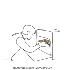 man with an open oven takes out or puts in a baking tray with cookies  - one line art vector. concept home cooking cookies