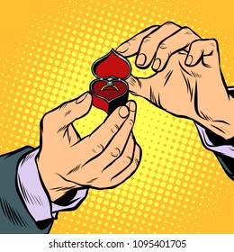 man opens a box with wedding ring. Pop art retro vector illustration kitsch vintage