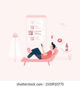 Man ordering take away food by internet with a laptop while lying at home. Order food on internet, restaurant meals delivery online