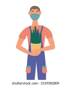 A man in overalls holding a flower in a pot, with a protective mask on his face. worker, moving, loader
