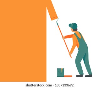 Man in overalls, working uniform with a roller paints, repaints the wall in orange color.