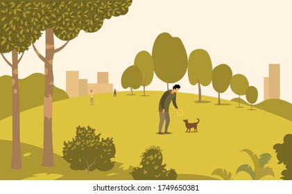 A man in a Park walks with a dog
