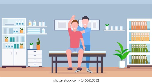 man patient sitting on table masseur therapist doing healing treatment massaging patient body manual sport physical therapy concept modern clinic hospital room interior horizontal