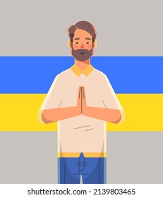 man patriot with Ukrainian flag asking for help pray for Ukraine peace save Ukraine from russia stop war concept