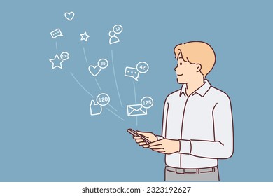 Man with phone uses social networks and apps to communicate with friends stands near icons symbolizing internet chatting. Guy with smartphone registers in social networks and instant messengers