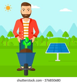 Man with plant and wheelbarrow.