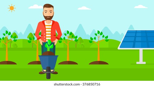 Man with plant and wheelbarrow.