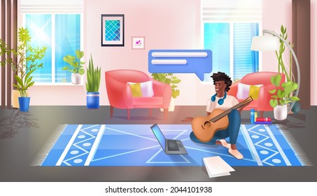 man playing guitar and using laptop social media network chat bubble communication concept
