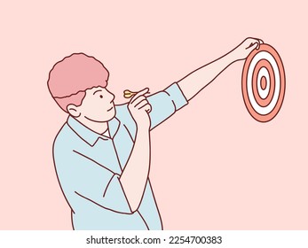 Man playing holding darts board and aiming little red arrow simple korean style illustration