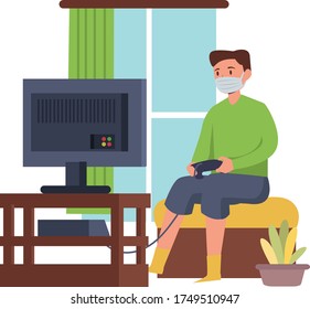 Man is playing video games alone at home while using medical mask