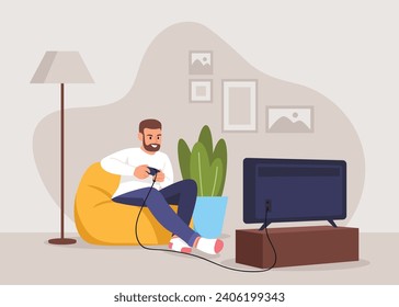 Man playing video games while sitting on an ottoman at home