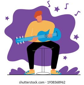 A man plays the guitar. A man sits on a chair and plays the guitar.