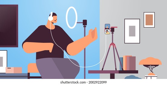 man podcaster talking to microphone recording video blog in studio podcasting online radio broadcasting live streaming