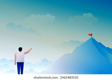 man pointing at flag on mountain top at dawn
